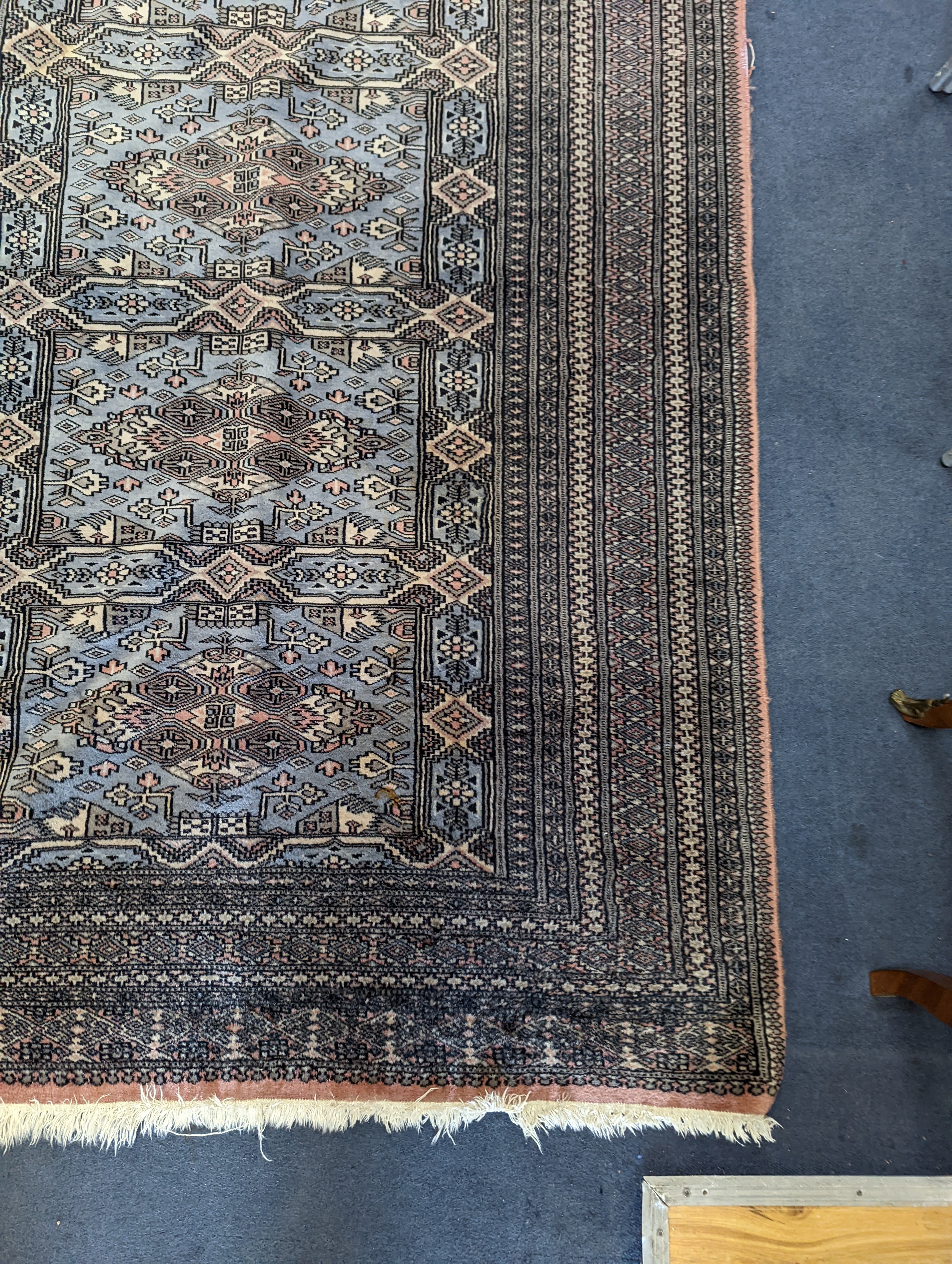 A Bokhara blue ground rug, 190 x 30cm